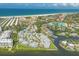 Aerial view of coastal community with sandy beach, a pool, private boat slips, and beautiful blue water at 1240 Siesta Bayside Dr # 1240C, Sarasota, FL 34242