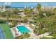Aerial view showcasing the community pool, tennis courts, and lush landscaping, offering a vibrant and active lifestyle at 1240 Siesta Bayside Dr # 1240C, Sarasota, FL 34242