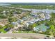 Aerial view of waterfront community featuring beautiful homes, tennis courts and lakes at 1240 Siesta Bayside Dr # 1240C, Sarasota, FL 34242