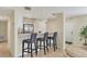 Stylish bar area featuring barstool seating and a view into the modern kitchen at 1240 Siesta Bayside Dr # 1240C, Sarasota, FL 34242