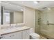 Bright bathroom featuring a glass shower, granite countertop, and large mirror at 1240 Siesta Bayside Dr # 1240C, Sarasota, FL 34242