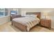 Bright bedroom with wooden furniture, a relaxing flat screen television, and calming natural light at 1240 Siesta Bayside Dr # 1240C, Sarasota, FL 34242