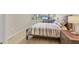 Cozy bedroom with a neutral color palette, natural wood furniture, and a view of the outdoors at 1240 Siesta Bayside Dr # 1240C, Sarasota, FL 34242