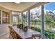 Bright dining room with a rustic table and a picturesque view of a serene lake and lush greenery at 1240 Siesta Bayside Dr # 1240C, Sarasota, FL 34242