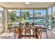 Spacious dining room with a view of the pool, a pond, and lush greenery at 1240 Siesta Bayside Dr # 1240C, Sarasota, FL 34242