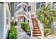 Inviting entrance with landscaped walkway, stairs to the upper level, and tasteful decor at 1240 Siesta Bayside Dr # 1240C, Sarasota, FL 34242