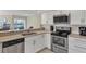 Modern kitchen with stainless steel appliances and a breakfast bar overlooking a view at 1240 Siesta Bayside Dr # 1240C, Sarasota, FL 34242