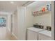 Laundry room features a stacked washer and dryer, plus shelving for extra storage at 1240 Siesta Bayside Dr # 1240C, Sarasota, FL 34242