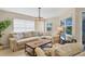 Comfortable living room featuring a large sectional sofa, a modern light fixture, and light, neutral walls at 1240 Siesta Bayside Dr # 1240C, Sarasota, FL 34242