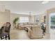 Bright living room with a cozy sectional sofa, modern light fixture, and views of the serene lake at 1240 Siesta Bayside Dr # 1240C, Sarasota, FL 34242