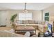 Bright living room with a large sectional sofa, natural light, and light hardwood flooring at 1240 Siesta Bayside Dr # 1240C, Sarasota, FL 34242