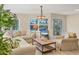 Bright living room with neutral tones, comfortable seating, and a view of lush landscaping at 1240 Siesta Bayside Dr # 1240C, Sarasota, FL 34242