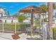 A quaint patio area with a table and chairs, perfect for outdoor dining and relaxing amidst the community at 1240 Siesta Bayside Dr # 1240C, Sarasota, FL 34242