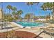 Community pool surrounded by lush landscaping, offering a refreshing escape and serene atmosphere for residents at 1240 Siesta Bayside Dr # 1240C, Sarasota, FL 34242