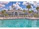 Community pool with lounge chairs and seating areas, perfect for relaxation and socializing under the sunny sky at 1240 Siesta Bayside Dr # 1240C, Sarasota, FL 34242