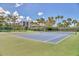 Well-maintained tennis court surrounded by lush landscaping, offering a great recreational amenity for residents at 1240 Siesta Bayside Dr # 1240C, Sarasota, FL 34242