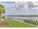 Waterfront view with lush greenery and a walking path along the canal at 1240 Siesta Bayside Dr # 1240C, Sarasota, FL 34242