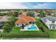 Aerial view of the backyard with pool, patio, and lush landscaping at 12814 Daisy Pl, Bradenton, FL 34212