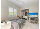 Bright bedroom with gray wood floor and ceiling fan, featuring a large walk-in closet at 12814 Daisy Pl, Bradenton, FL 34212