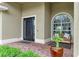 Charming front porch with brick flooring, comfortable seating, and decorative plants at 12814 Daisy Pl, Bradenton, FL 34212