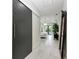 Bright hallway featuring a barn door, white floors, and access to the main bedroom and ensuite at 12814 Daisy Pl, Bradenton, FL 34212