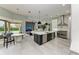 Gourmet kitchen with stainless steel appliances, marble backsplash, and a large center island at 12814 Daisy Pl, Bradenton, FL 34212