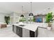 Spacious kitchen island features stainless steel sink and dishwasher, connecting to a cozy living space at 12814 Daisy Pl, Bradenton, FL 34212