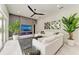 Stylish living room with a modern fireplace, large TV, and comfortable seating with pool view at 12814 Daisy Pl, Bradenton, FL 34212