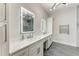 Bright main bathroom features double vanity with white marble counters and modern lighting at 12814 Daisy Pl, Bradenton, FL 34212