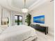 Bright main bedroom featuring modern chandelier, decor, and access to pool area at 12814 Daisy Pl, Bradenton, FL 34212