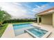 Beautiful backyard pool and hot tub with lush landscaping and a spacious patio at 12814 Daisy Pl, Bradenton, FL 34212