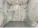 Oversized shower features dual shower heads, tiled walls, and gray tiled floor at 12814 Daisy Pl, Bradenton, FL 34212