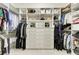 Spacious walk-in closet features custom shelving, cabinetry, and white marble countertop at 12814 Daisy Pl, Bradenton, FL 34212