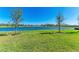 Lush green backyard overlooking a scenic lake view on a sunny day at 12827 Lily Quartz Loop, Parrish, FL 34219