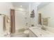 Bathroom featuring a shower-tub combination, white subway tile and a marble countertop at 12827 Lily Quartz Loop, Parrish, FL 34219