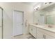 Bright bathroom featuring double sinks, modern fixtures, and a large mirror at 12827 Lily Quartz Loop, Parrish, FL 34219