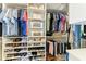 Spacious walk-in closet with shelves and hanging rods for optimal organization of clothing and accessories at 12827 Lily Quartz Loop, Parrish, FL 34219