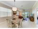 Inviting dining area with views of the yard and lake, featuring a stylish table and comfortable seating at 12827 Lily Quartz Loop, Parrish, FL 34219