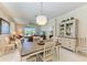Open-concept dining area with stylish table and chairs, built-in cabinet, and bright lighting near the living room at 12827 Lily Quartz Loop, Parrish, FL 34219
