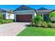 Charming home featuring a spacious two-car garage, well-manicured lawn, and a welcoming facade at 12827 Lily Quartz Loop, Parrish, FL 34219