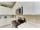 Elegant kitchen with stainless steel appliances, granite countertops, and stylish backsplash at 12827 Lily Quartz Loop, Parrish, FL 34219
