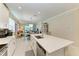Bright, open kitchen with a large island, stainless steel appliances, and views of the living area at 12827 Lily Quartz Loop, Parrish, FL 34219
