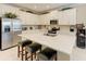 Modern kitchen with stainless steel appliances, granite countertops, and a breakfast bar with seating at 12827 Lily Quartz Loop, Parrish, FL 34219