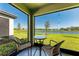 Relaxing screened lanai with seating and lake view at 12827 Lily Quartz Loop, Parrish, FL 34219