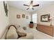 Cozy living room with wicker dresser, ceiling fan, and comfortable seating at 12827 Lily Quartz Loop, Parrish, FL 34219