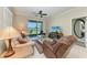 Cozy living room with a view of the outdoors, comfortable seating, and sliding glass doors to the lanai at 12827 Lily Quartz Loop, Parrish, FL 34219