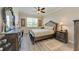 Well-lit main bedroom featuring a comfortable bed, stylish dressers, bedside tables, and refined decor at 12827 Lily Quartz Loop, Parrish, FL 34219