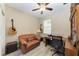 Cozy home office with a comfortable leather couch and desk setup at 12827 Lily Quartz Loop, Parrish, FL 34219