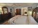 Comfortable bedroom featuring hardwood floors, a colorful quilt, and warm lighting at 1308 63Rd Nw St, Bradenton, FL 34209