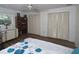 Bedroom featuring a floral-patterned bedspread, closet, and hardwood flooring at 1308 63Rd Nw St, Bradenton, FL 34209